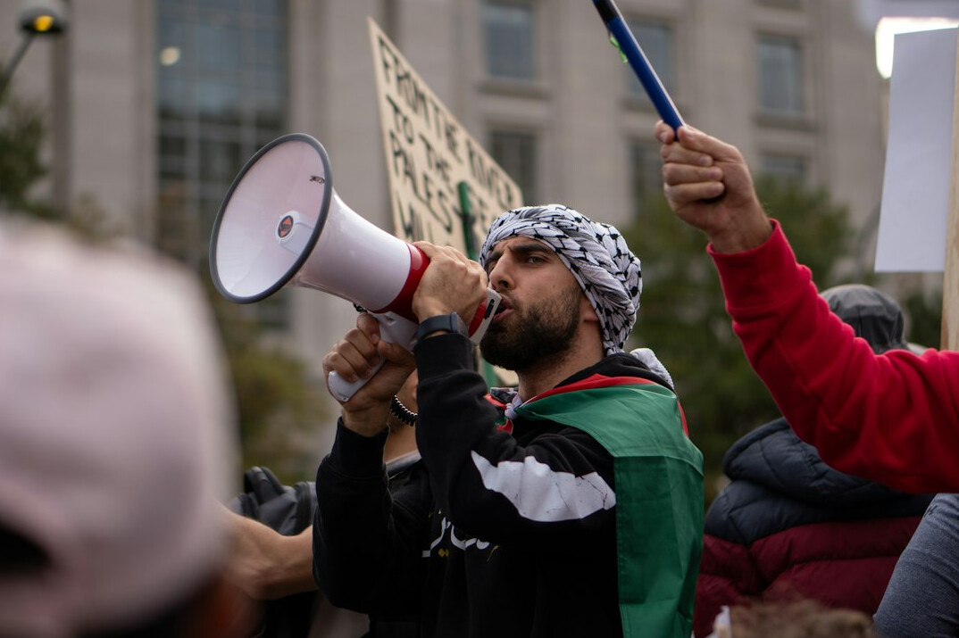 Turkish male field reporter holding a microphone